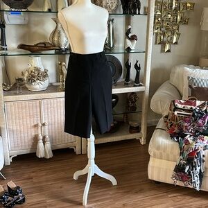 Knee length shorts with buttons on the side belt in back